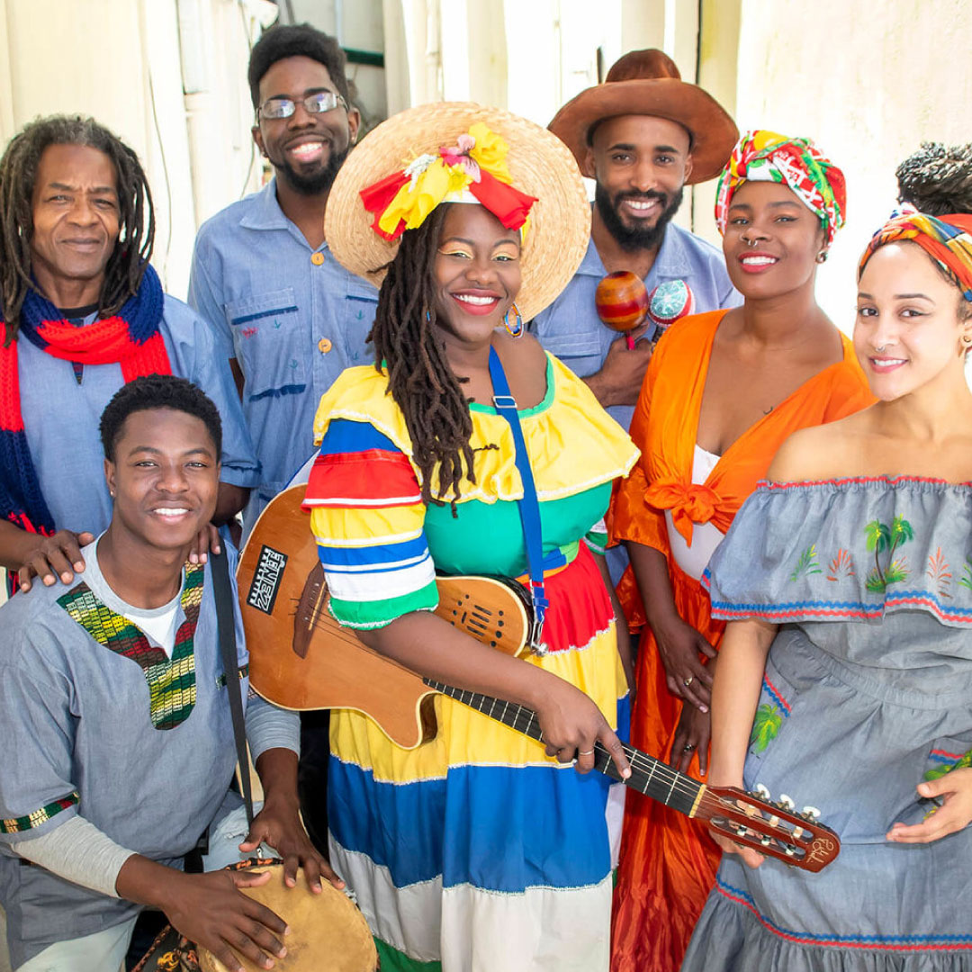 tatinuzi haitian group tati nuzi and friends stands together wearing colorful outfits