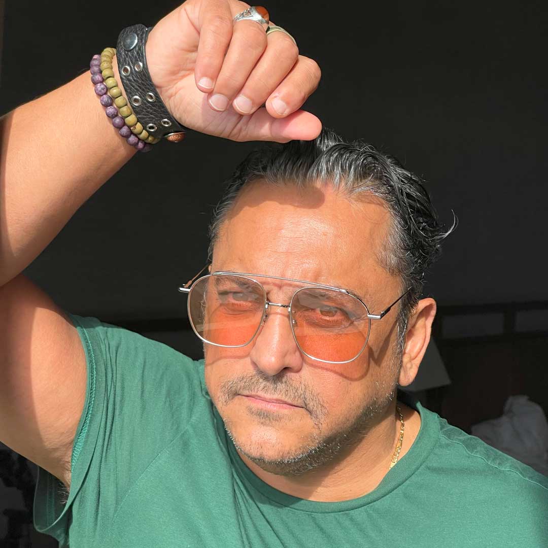 A photo of Siavash, a man wearing sunglasses and posed with hand above his head