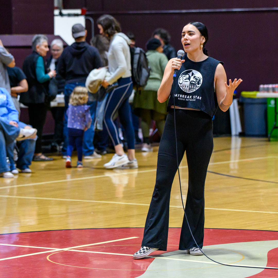 a pow wow dancer with her arms outstretched
