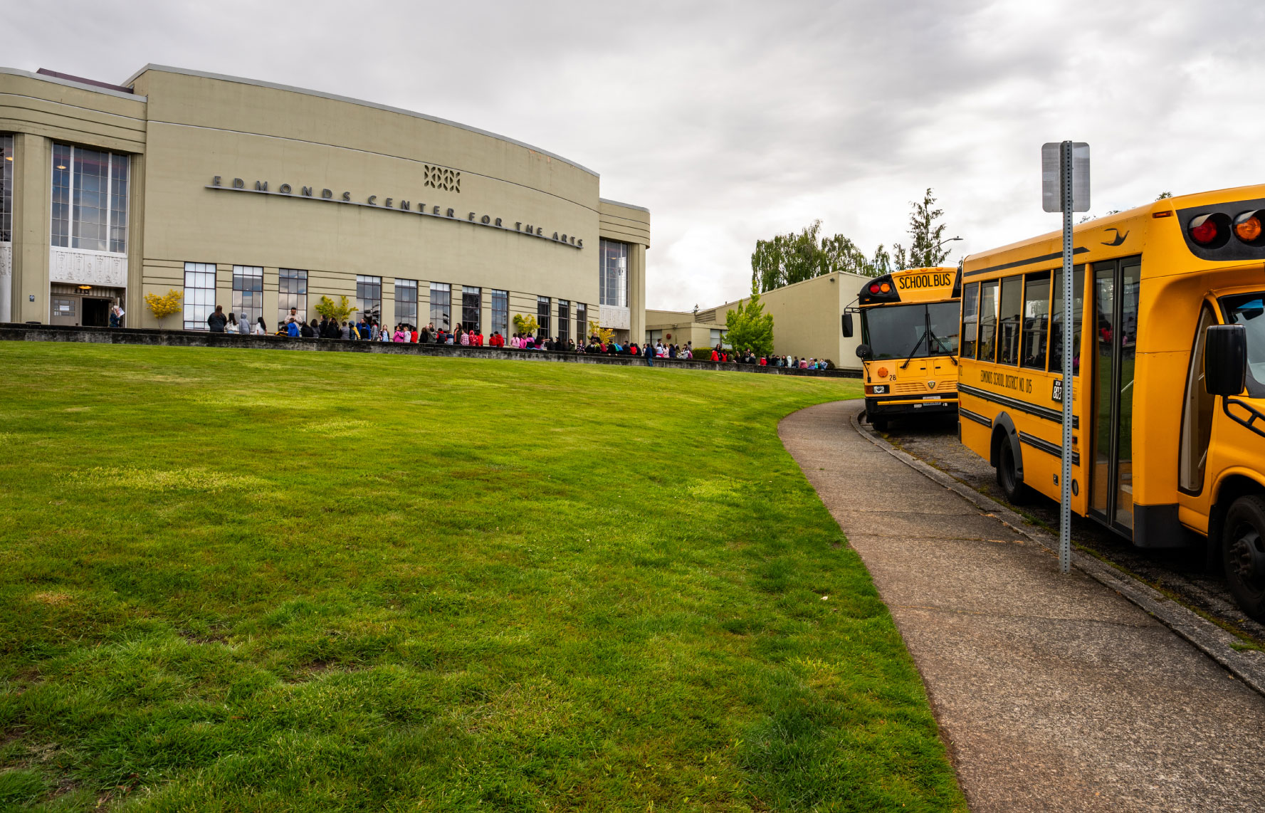 onstage photo of ms frizzle and group riding the magic school bus in the stage production